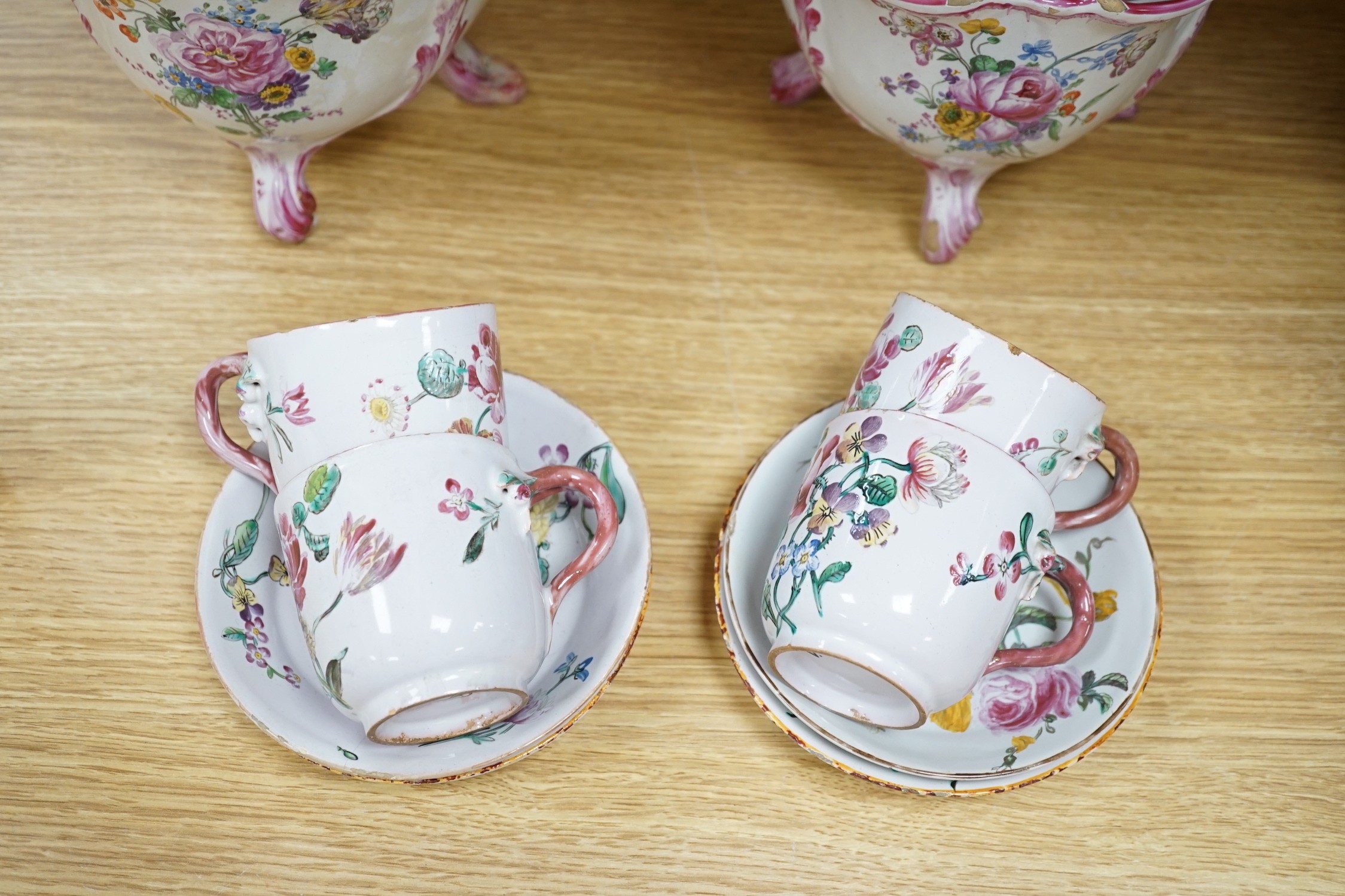 A group of of French faience pottery including a pair of pot pourri vases and covers, a tureen with integral stand, cover, ladle and four coffee cups and saucers